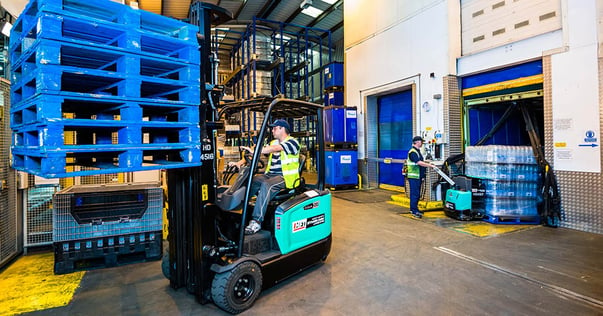 Electric counterbalance forklift in warehouse